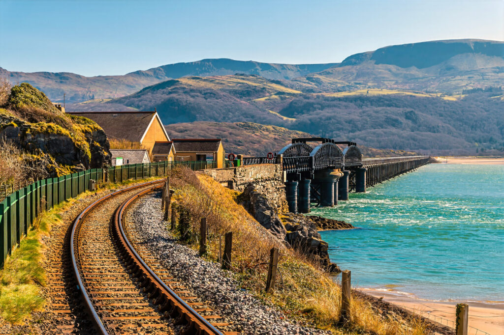 A view along the railway line towards the railway bridge at Barmouth, Wales in springtime