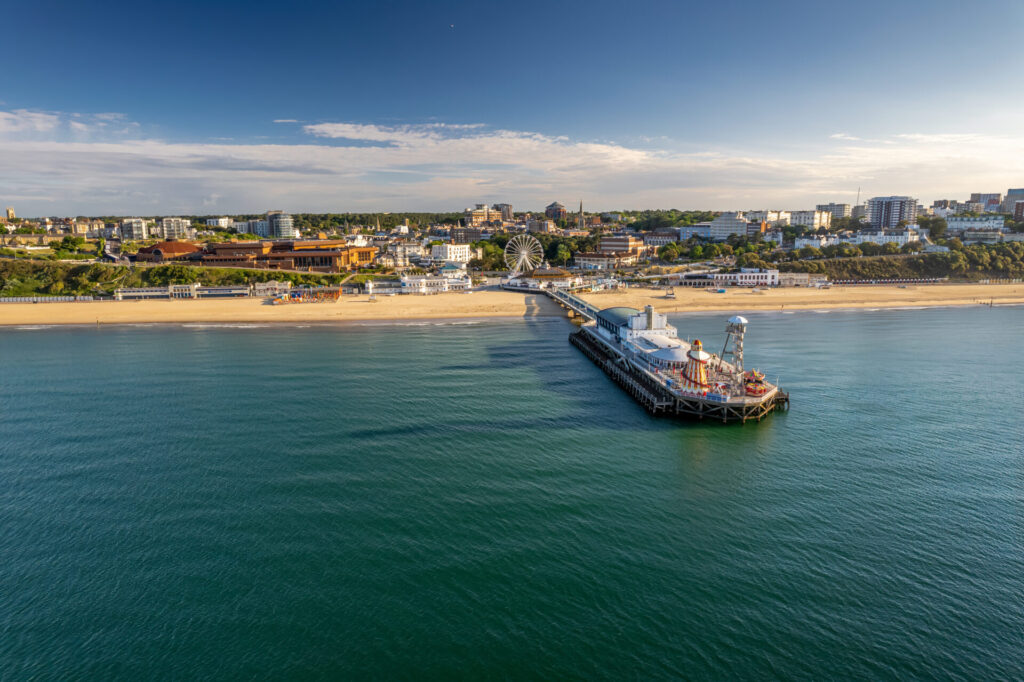 The drone aerial view of the Bournemouth beach, Observation Wheel and Pier. Bournemouth is a coastal resort town in the Bournemouth, Christchurch and Poole council area of Dorset, England.