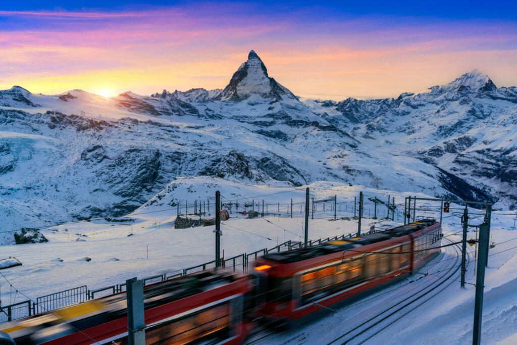 A train passes the Matterhorn at dawn