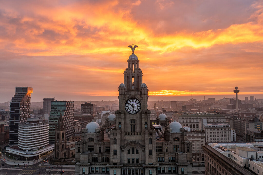 The sun sets behind the Royal Liver Building