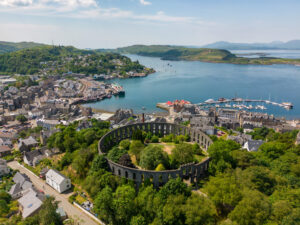 Drone photo of Mccraig's tower and the harbour town of Oban in Scotland.